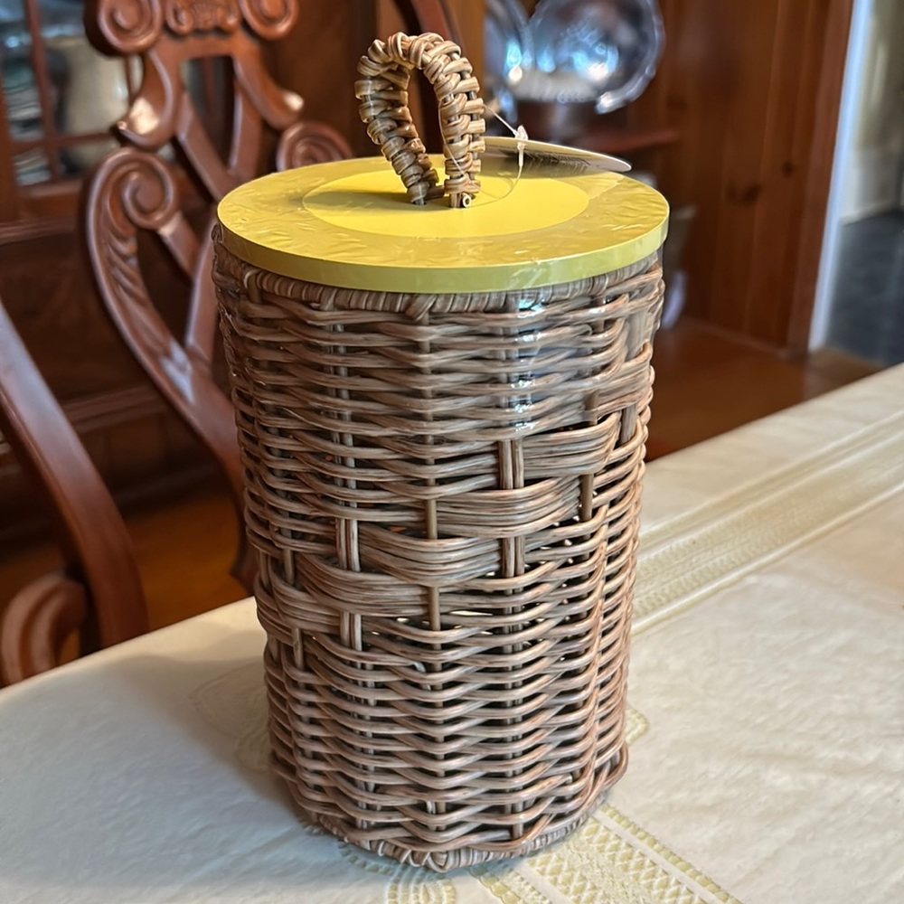 Wicker canister with yellow lid. Perfect storage for the bathroom or kitchen.